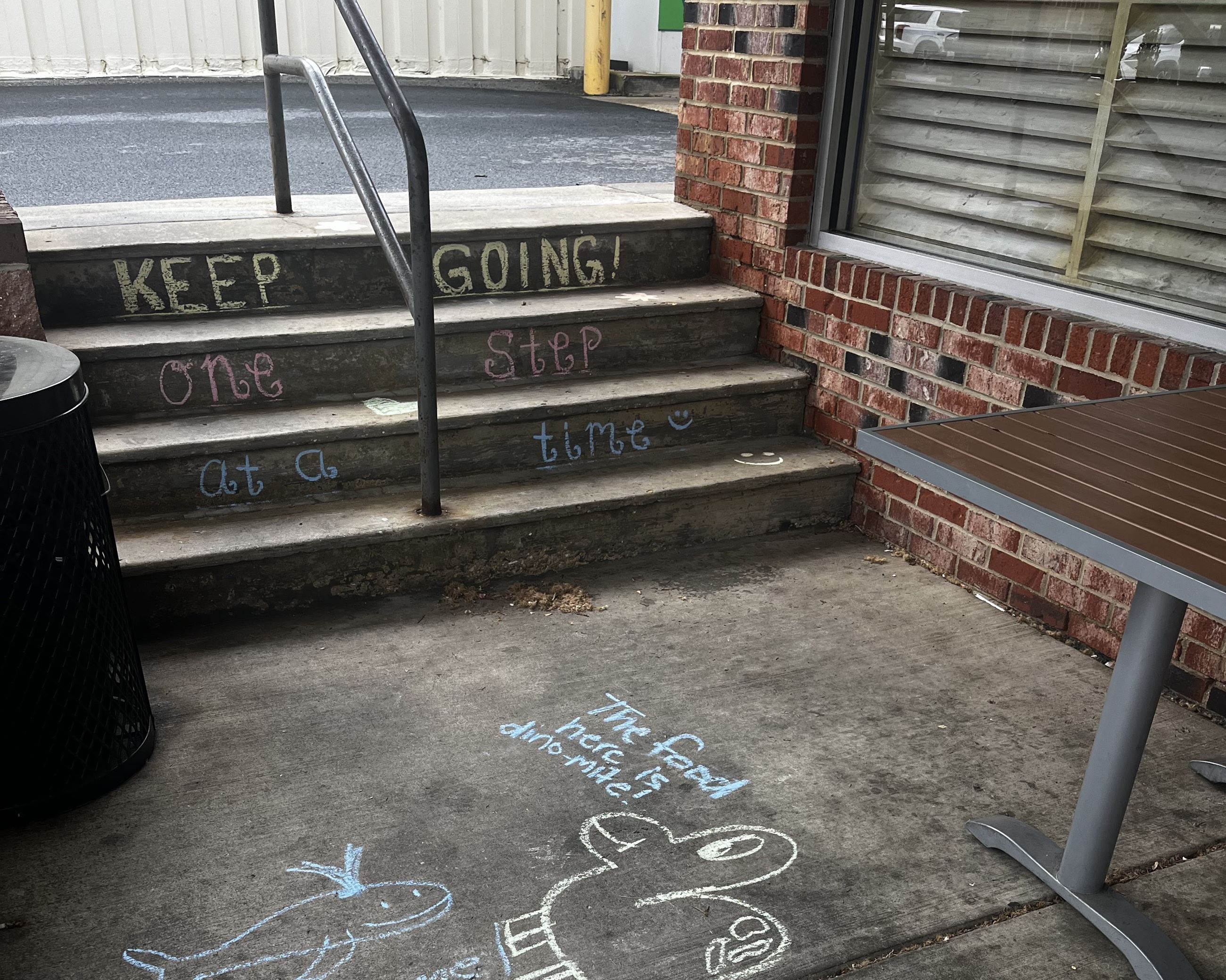 Multicolored sidewalk chalk art rainbow and sun with text "Chalk the Walk! Spread positivity"