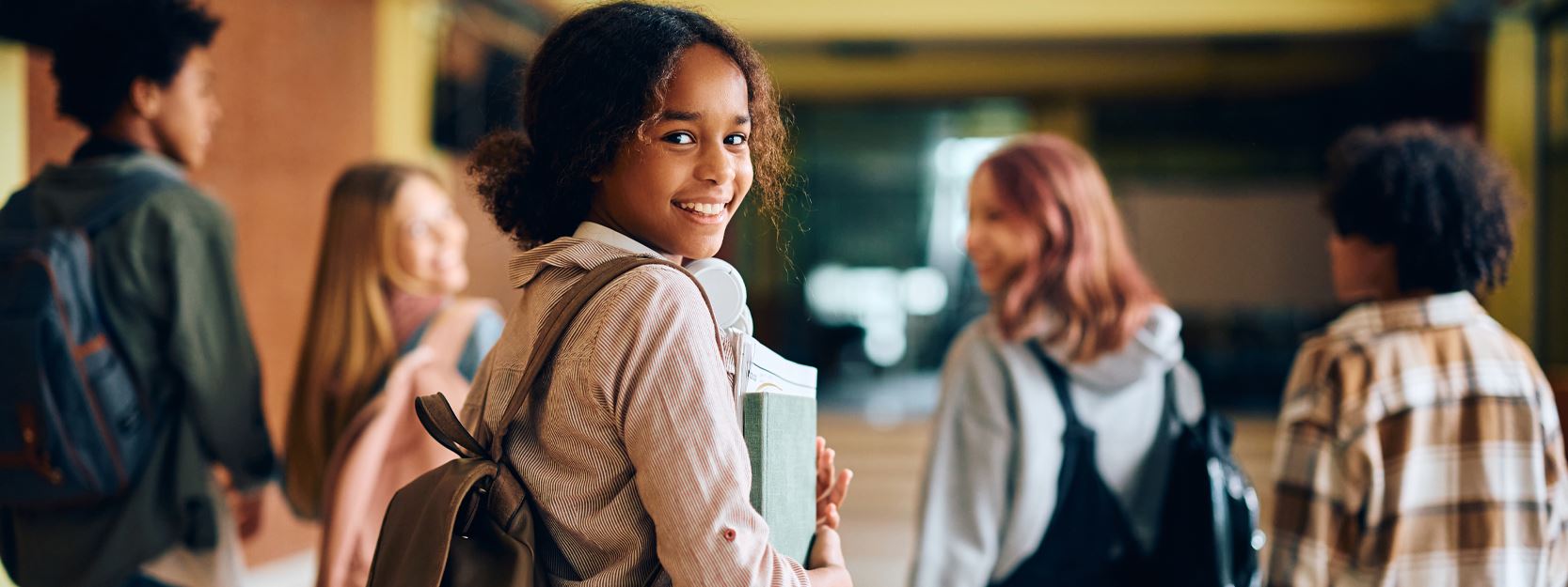 Kids in the hallway walking with books