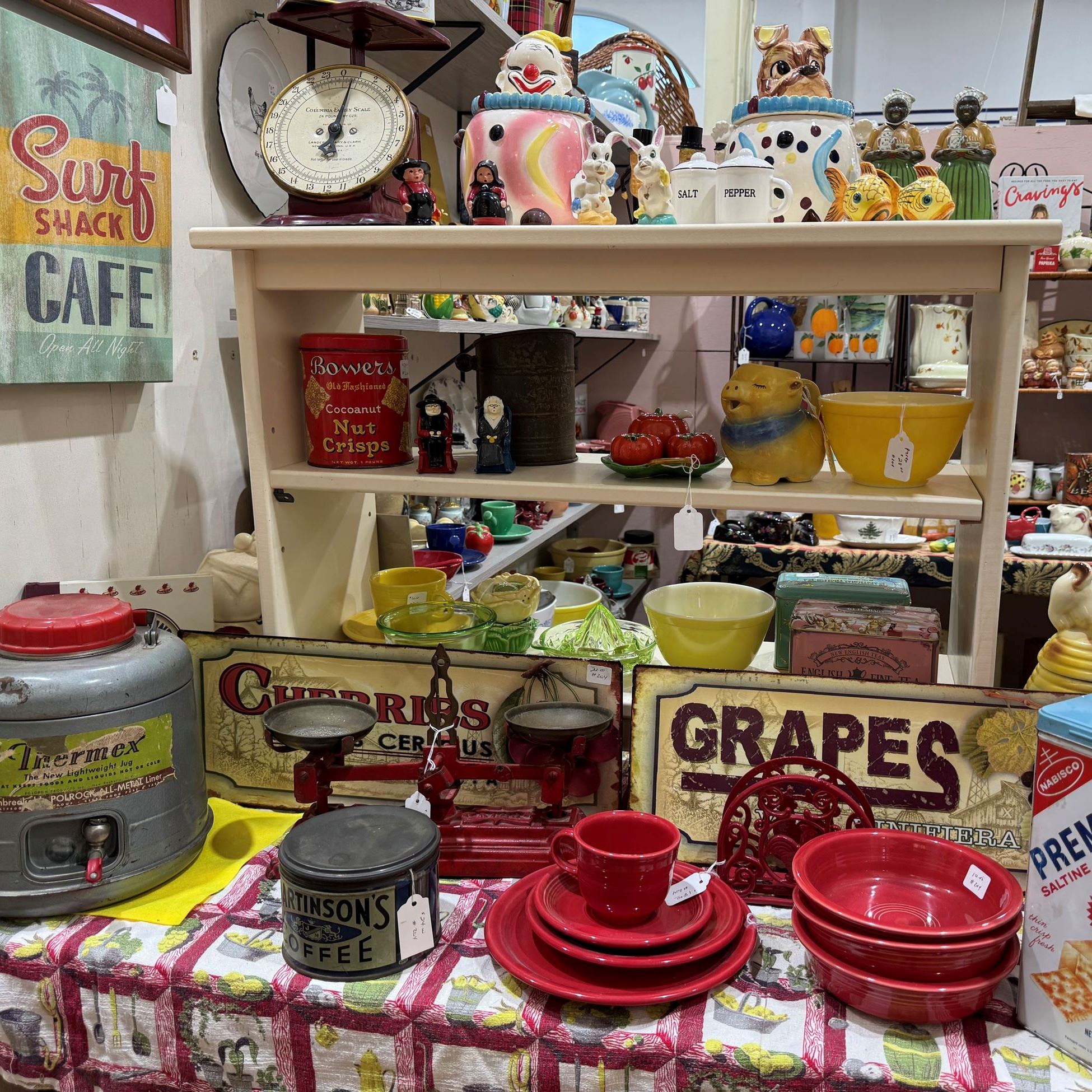 dishes food containers and kitchen accessories on a table and shelves